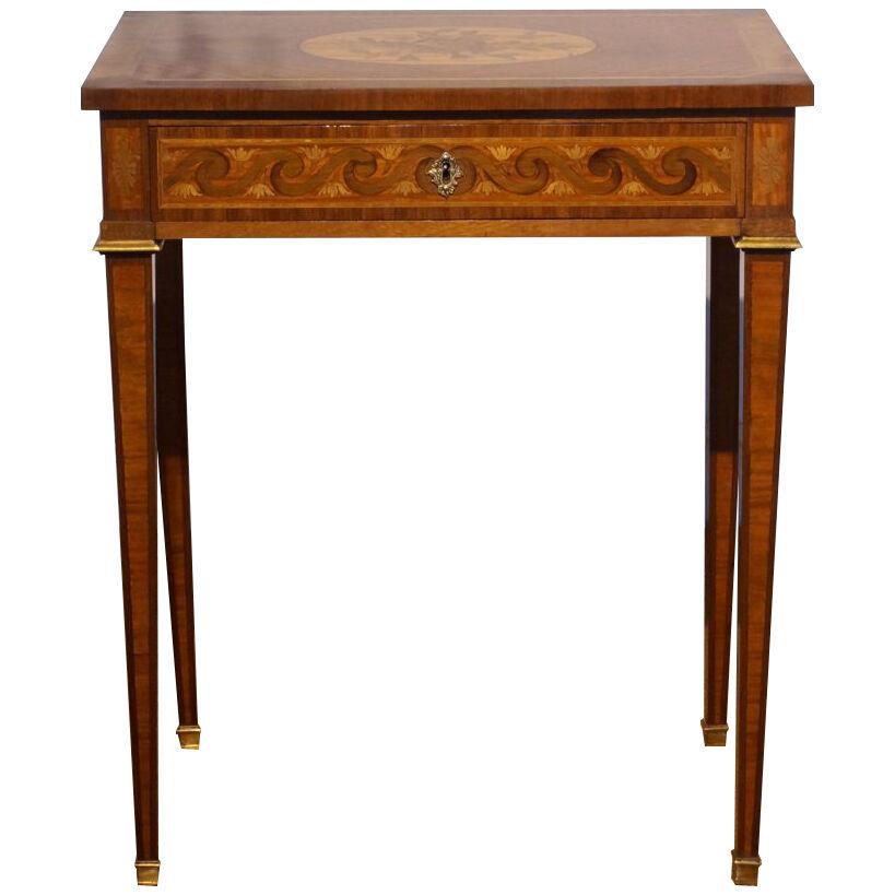 A mid-19th century French marquetry centre table with gilt metal mounts.