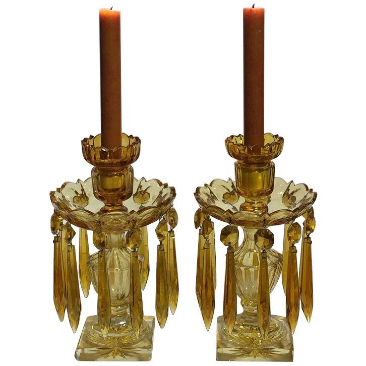 A pair of cut amber cut glass lustre candlesticks