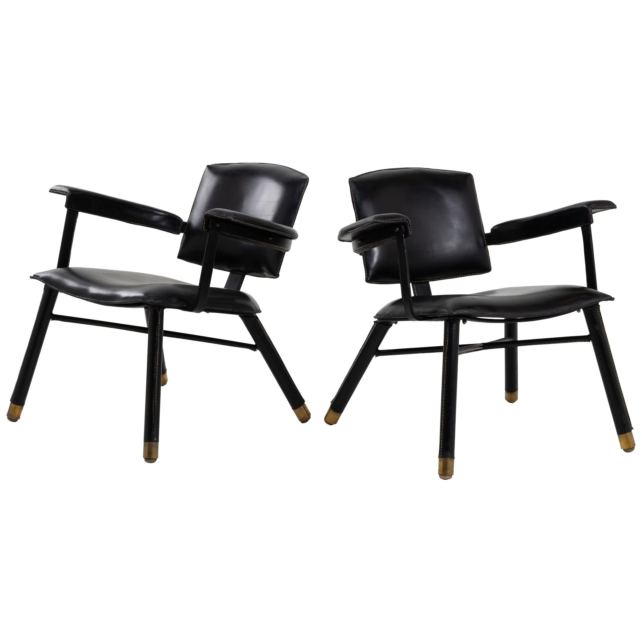 Pair of black leather armchairs called “chauffeuse” by Jacques Adnet