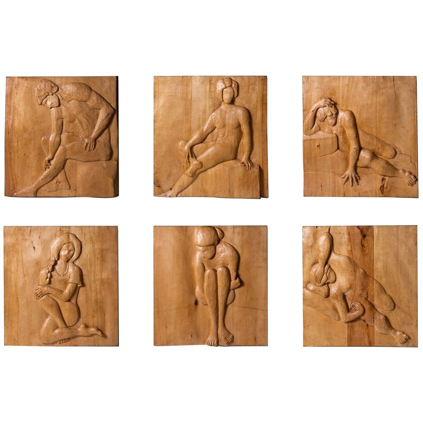Six decorative panels, carved wood in low relief