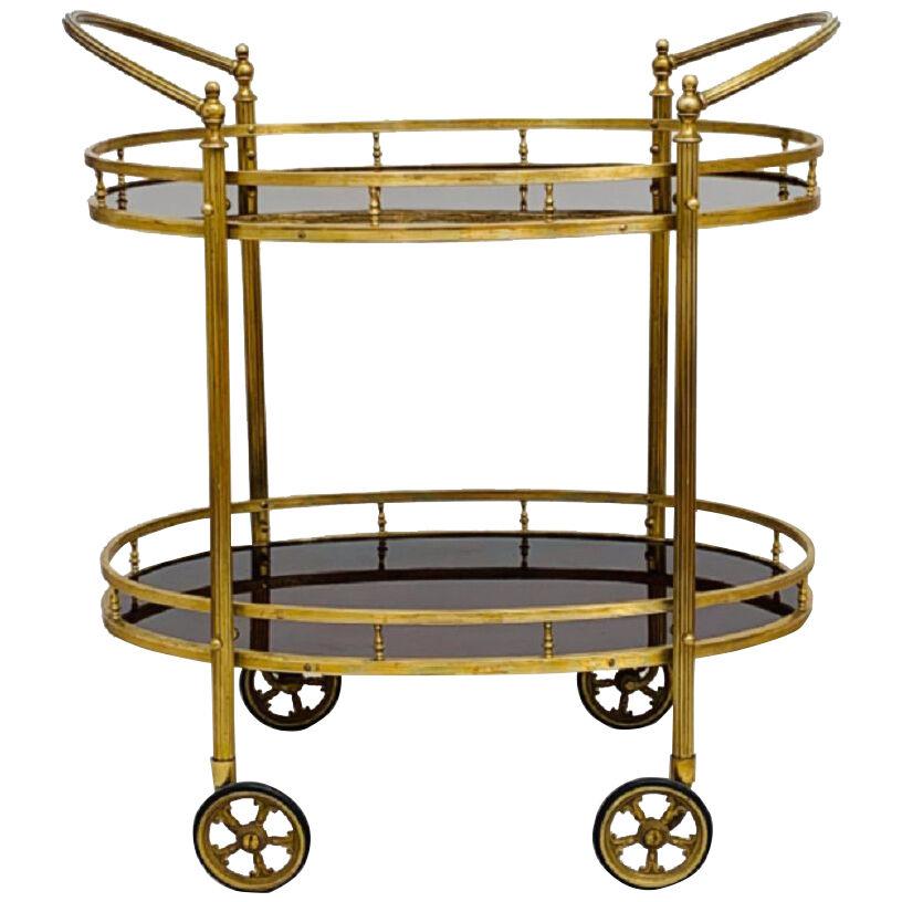 CIRCA 1960  TWO  TIERED  OVAL BRASS SERVING TROLLEY
