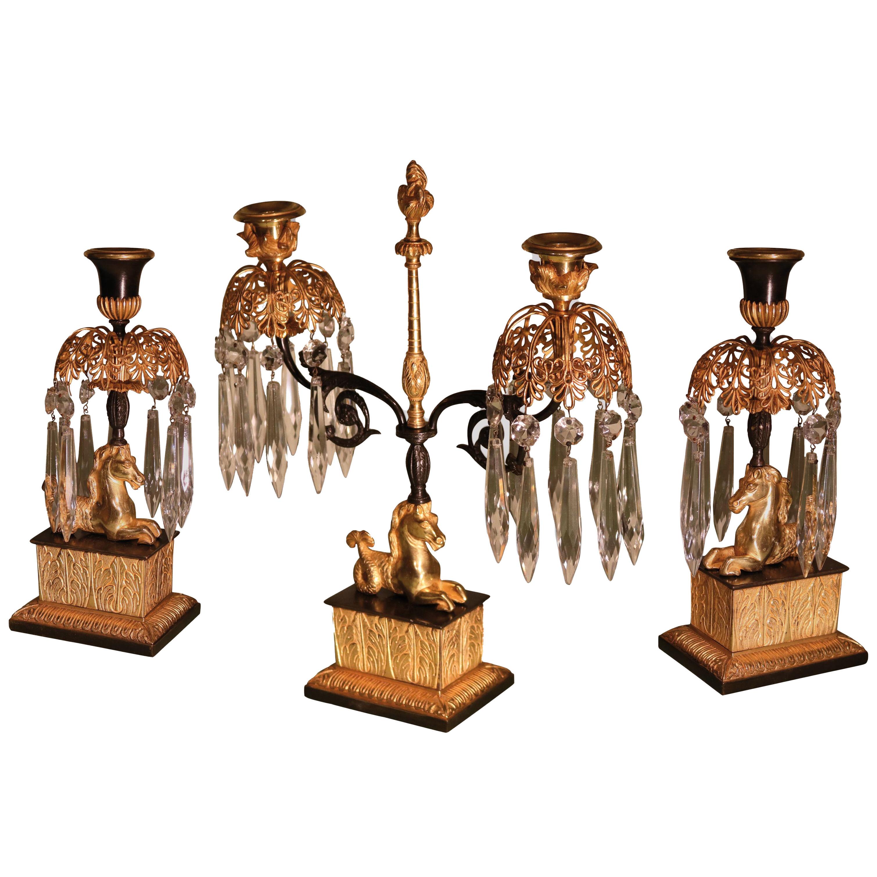 A set of early 19th century bronze and ormolu lustre candlesticks