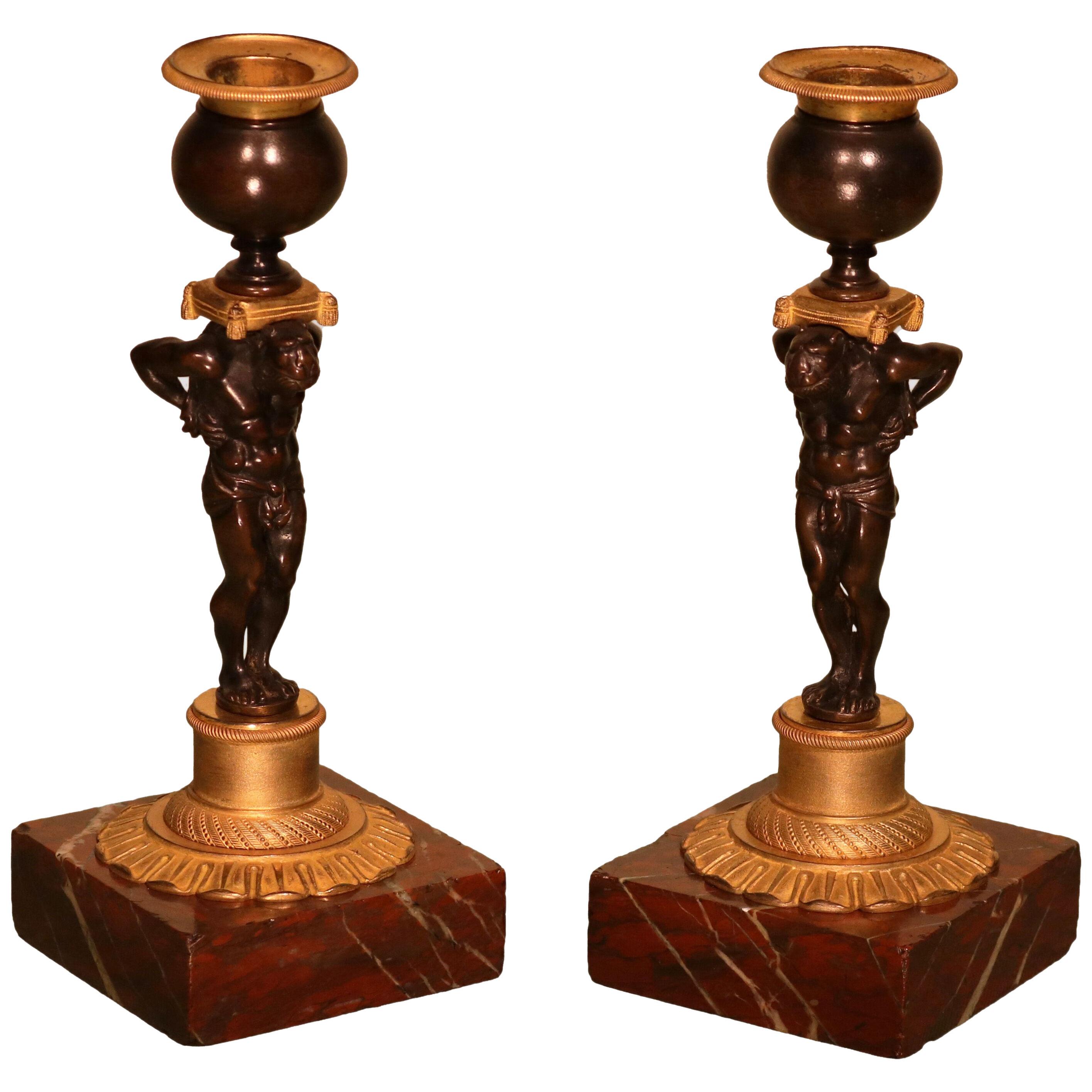 A pair of early 19th century Regency period candlesticks in the form of Atlas