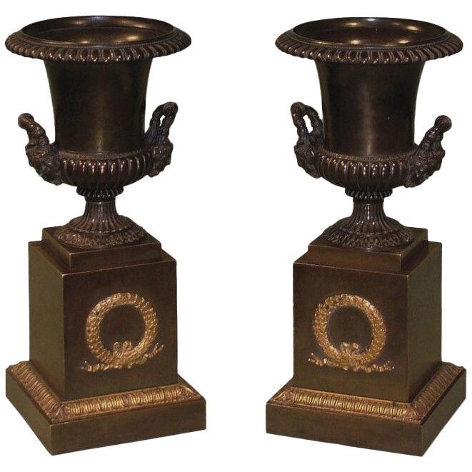 A pair of early 19th Century bronze and ormolu Campana shaped Urns.
