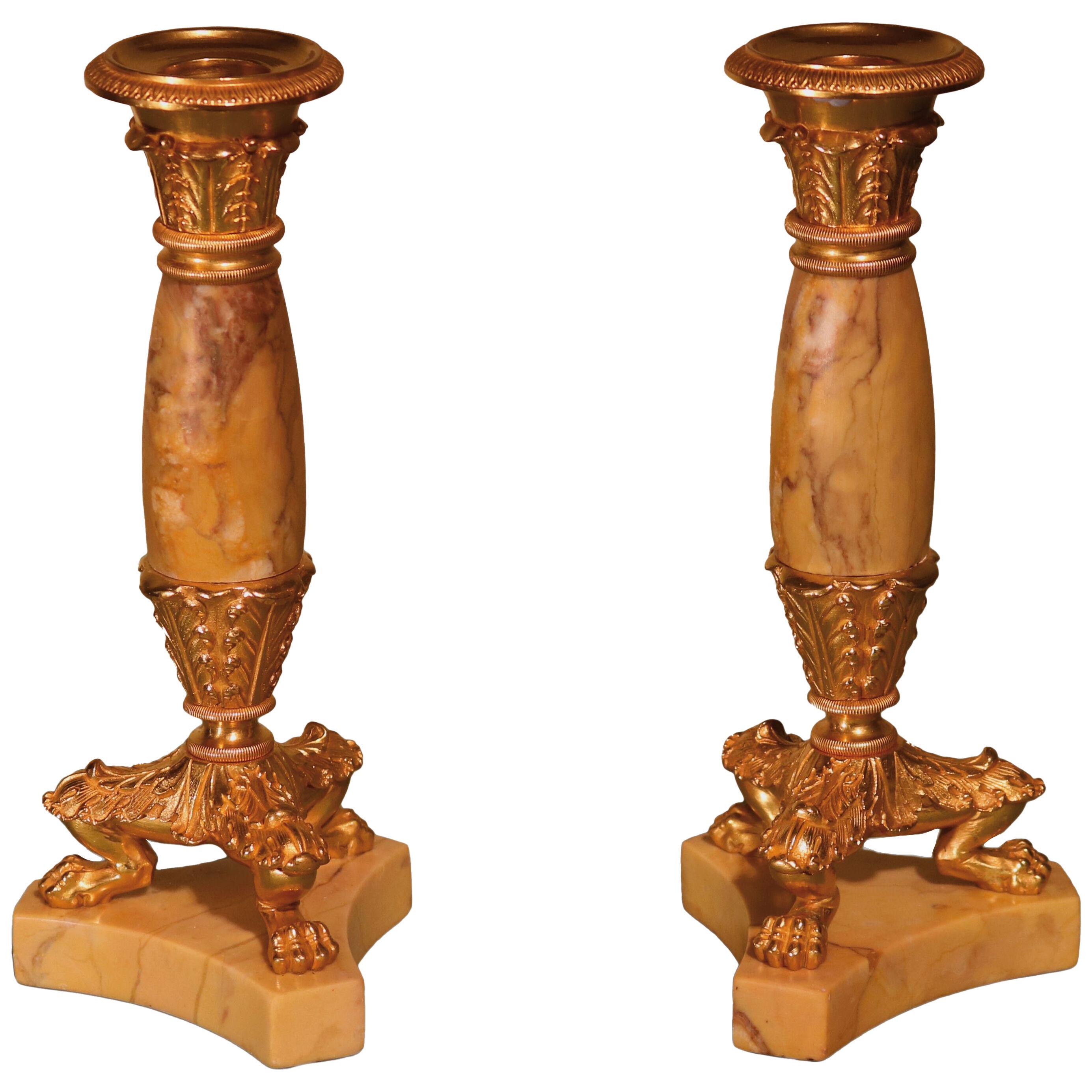A pair of early 19th century bronze and ormolu bulbous shaped candlesticks