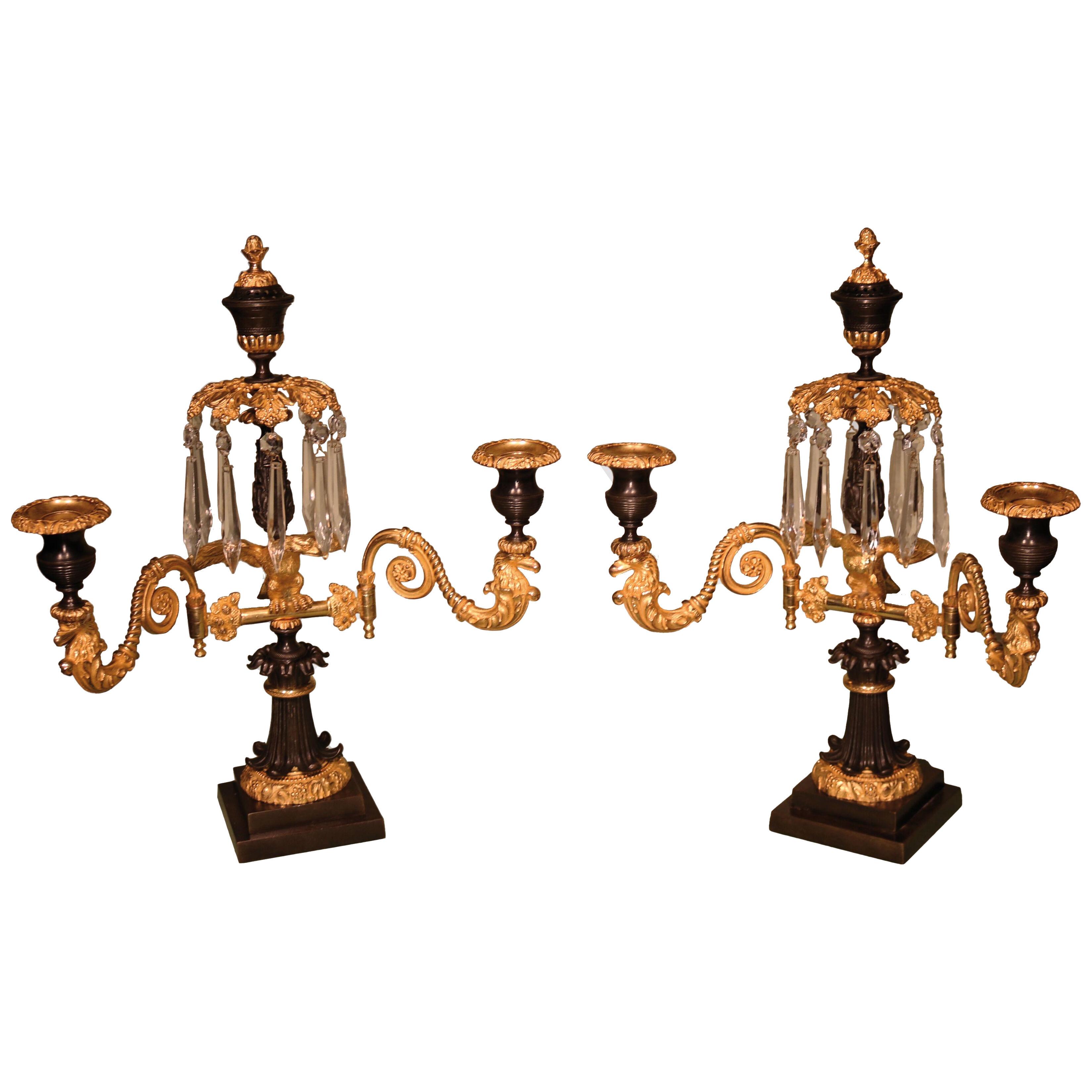 A Pair of 19th century Regency period bronze and ormolu two light candelabra