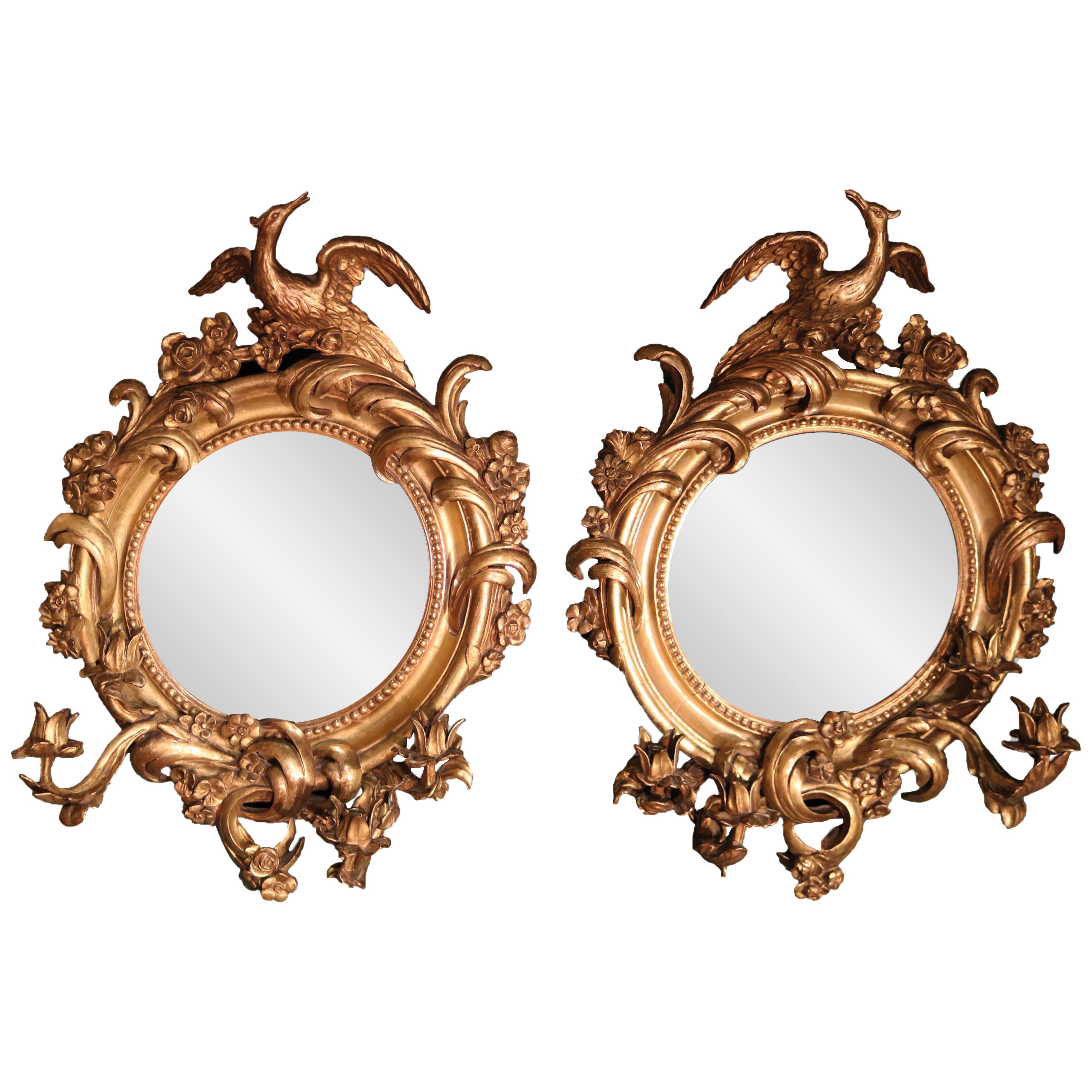 A pair of mid 19th century giltwood convex mirrors