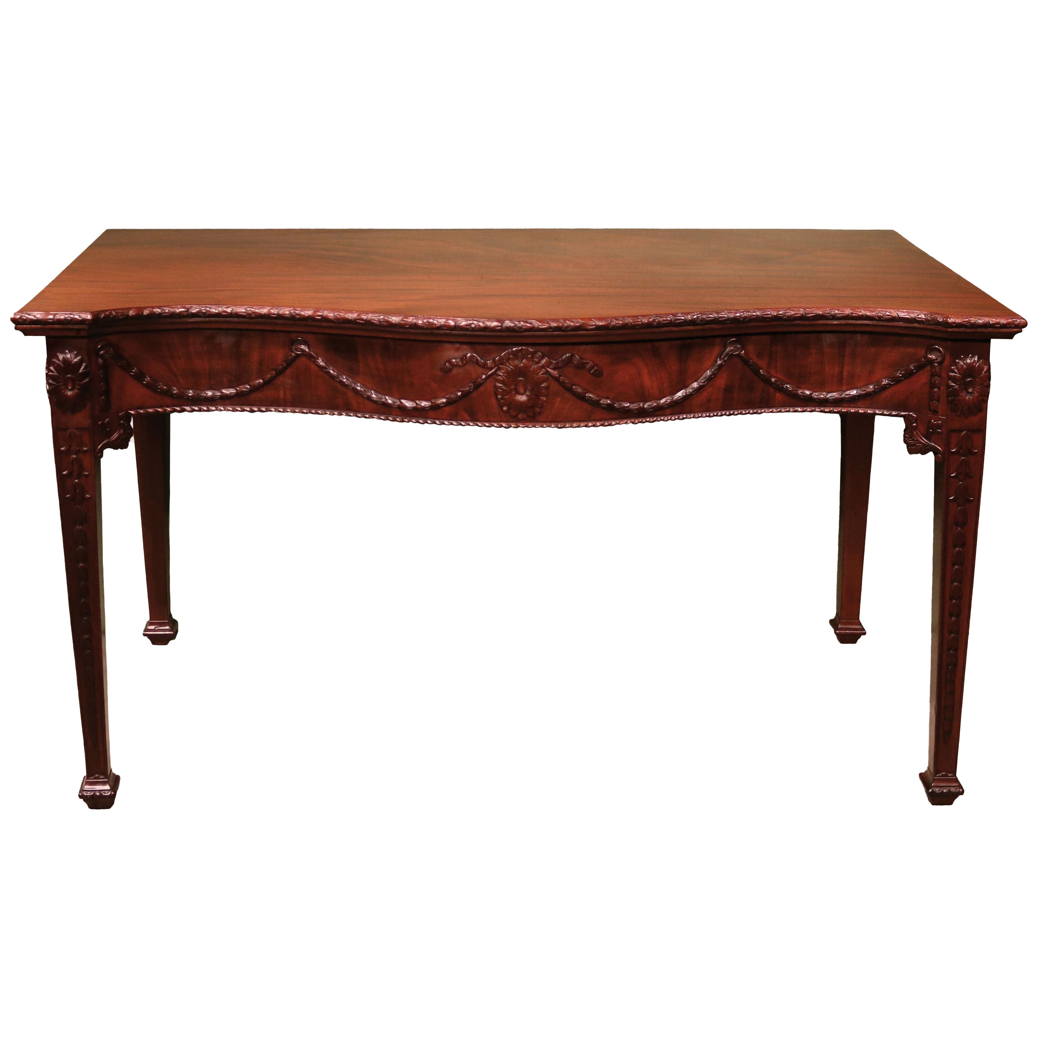 A George III period carved mahogany serpentine serving table.