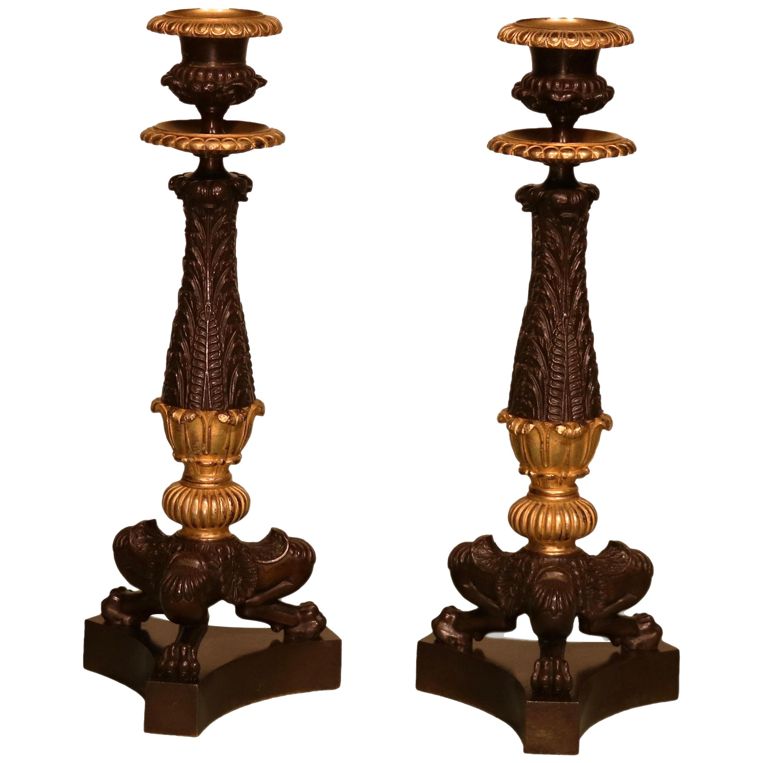 A pair of 19th century Regency period bronze and ormolu candlesticks