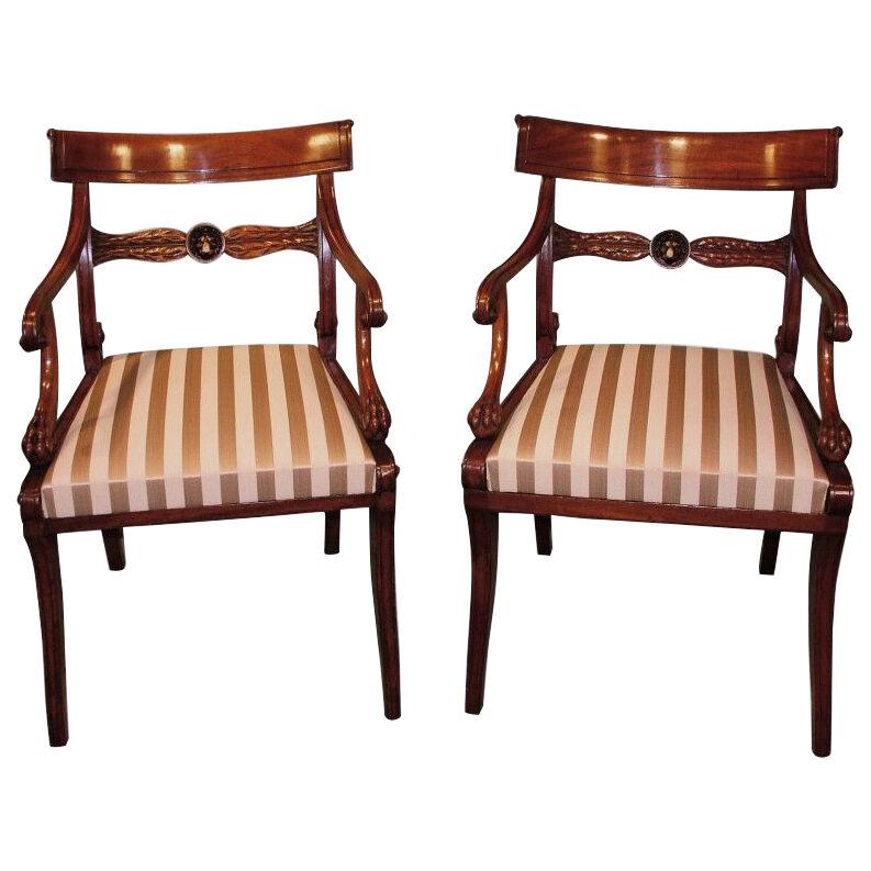  A matched pair of early 19th Century mahogany Arm Chairs.