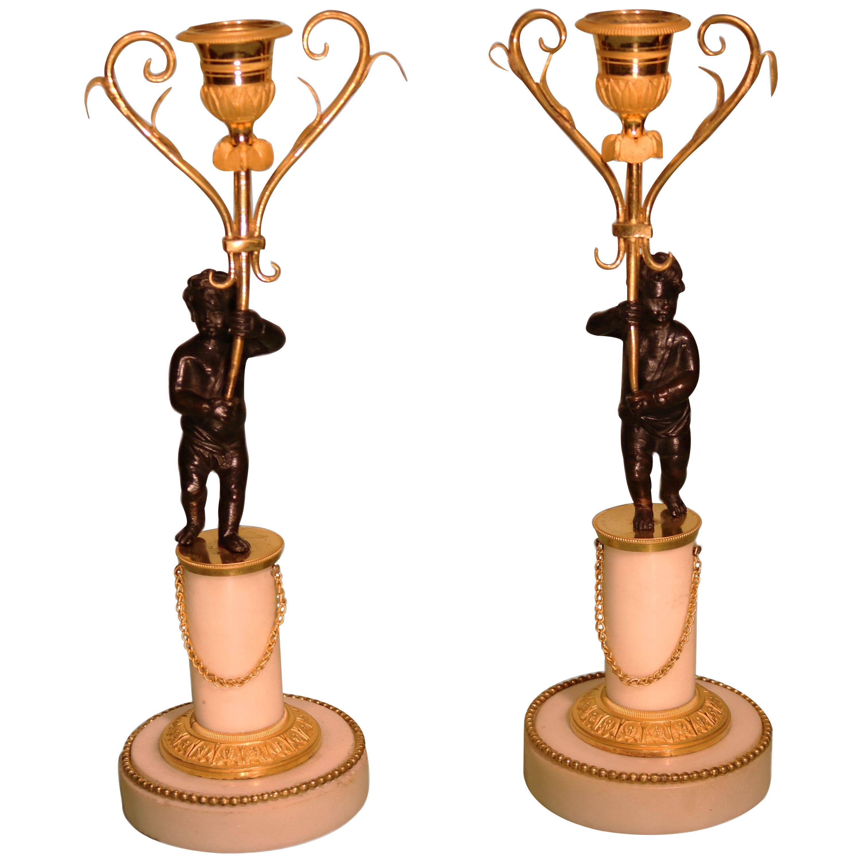 A pair of 19th century white marble and bronze and ormolu candlesticks