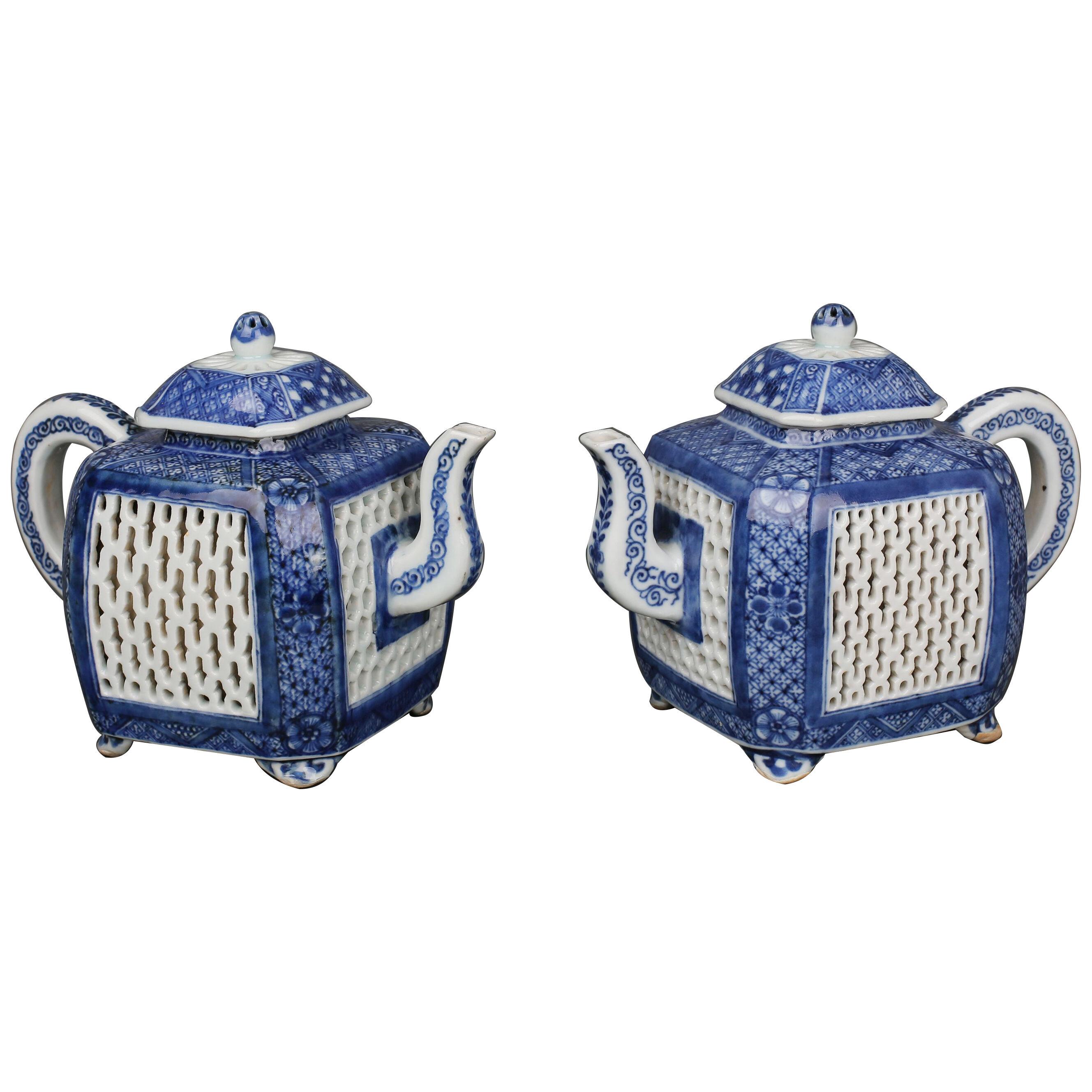 A pair of Chinese porcelain blue and white reticulated square teapots and covers