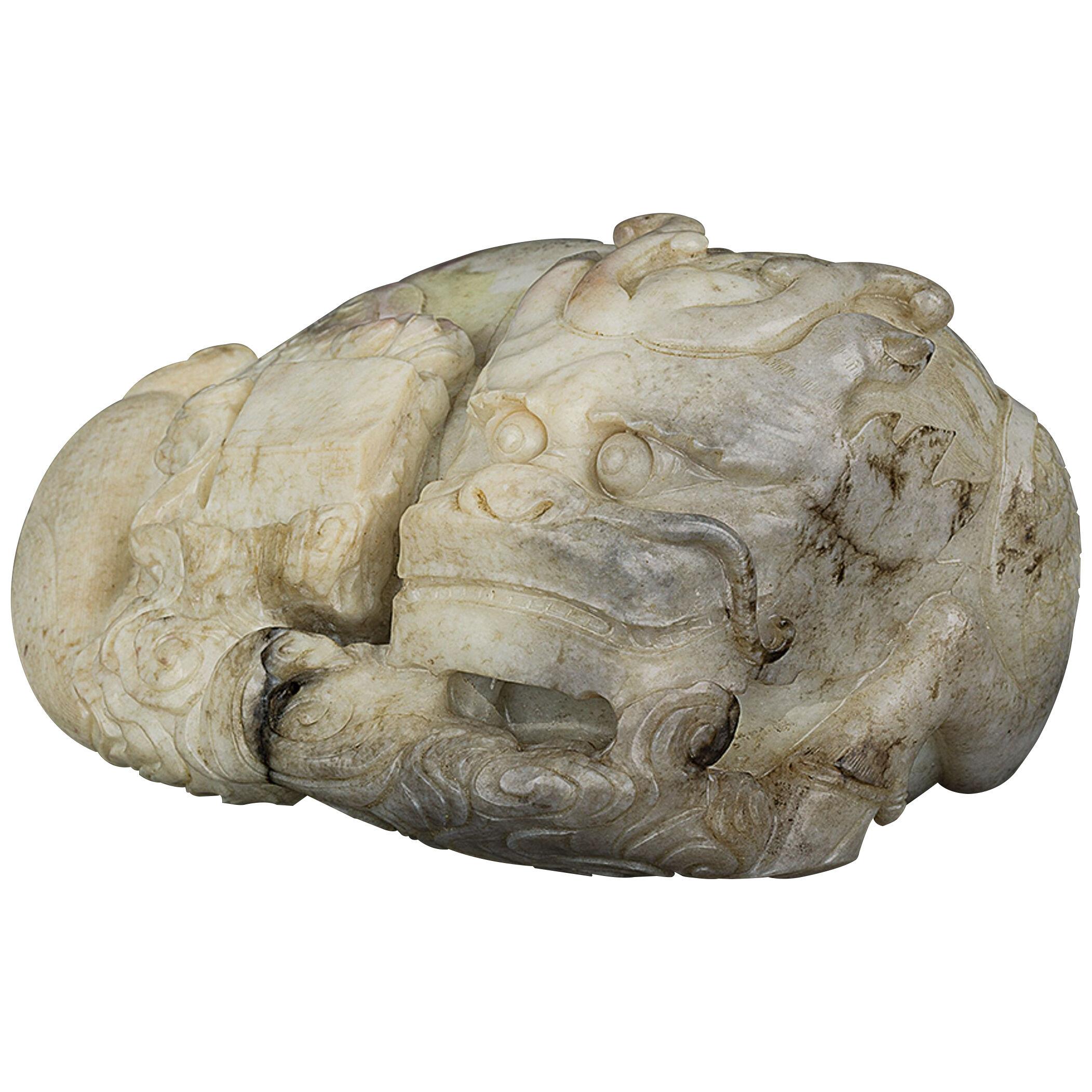 Chinese large jade recumbent qilin resting amongst ruyi-clouds supporting a book