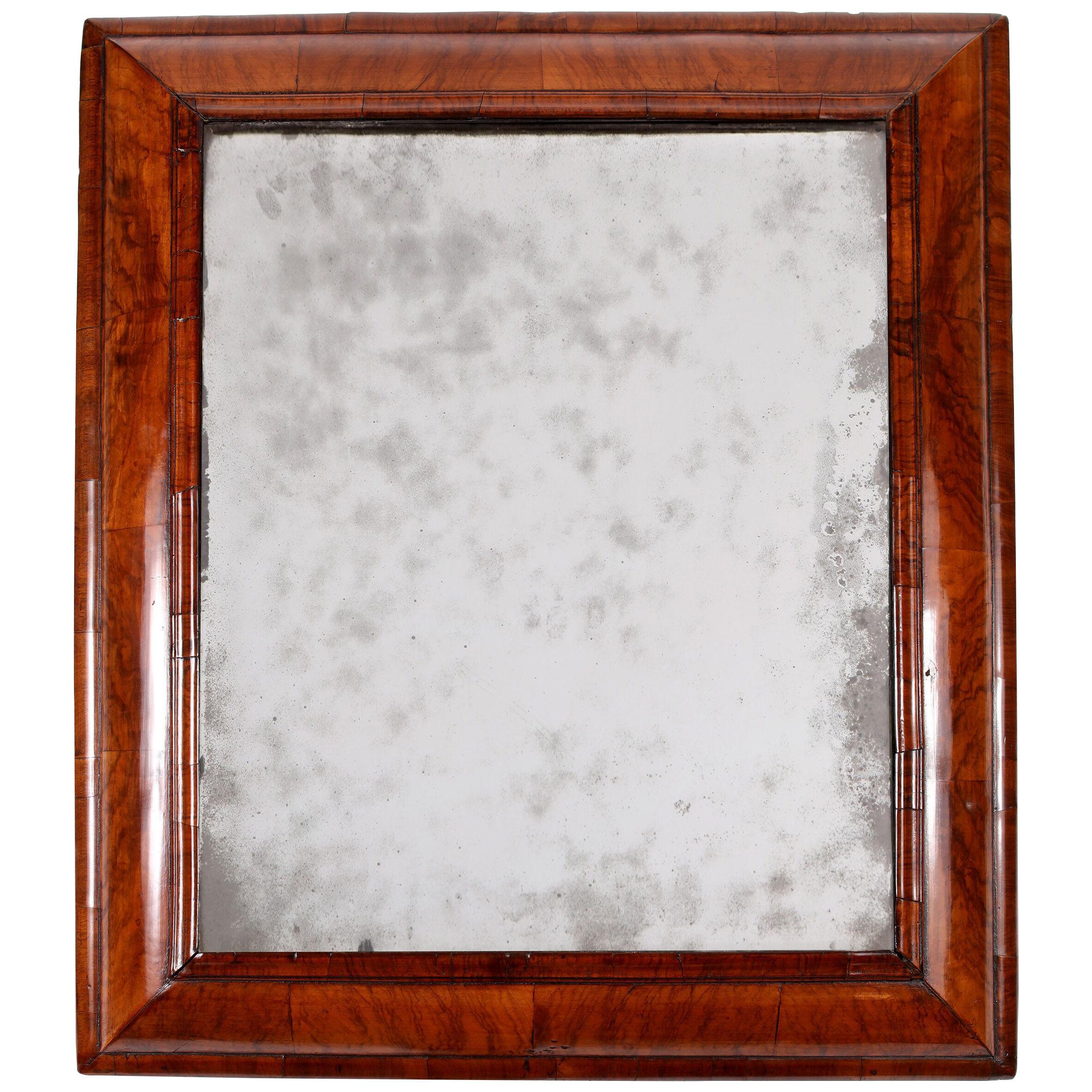 A William & Mary cushion-framed mirror
