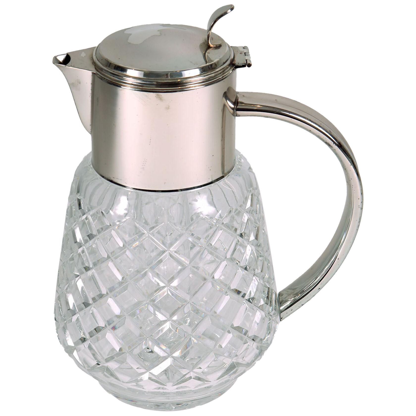 An early 20th century silver plated and cut glass serving jug