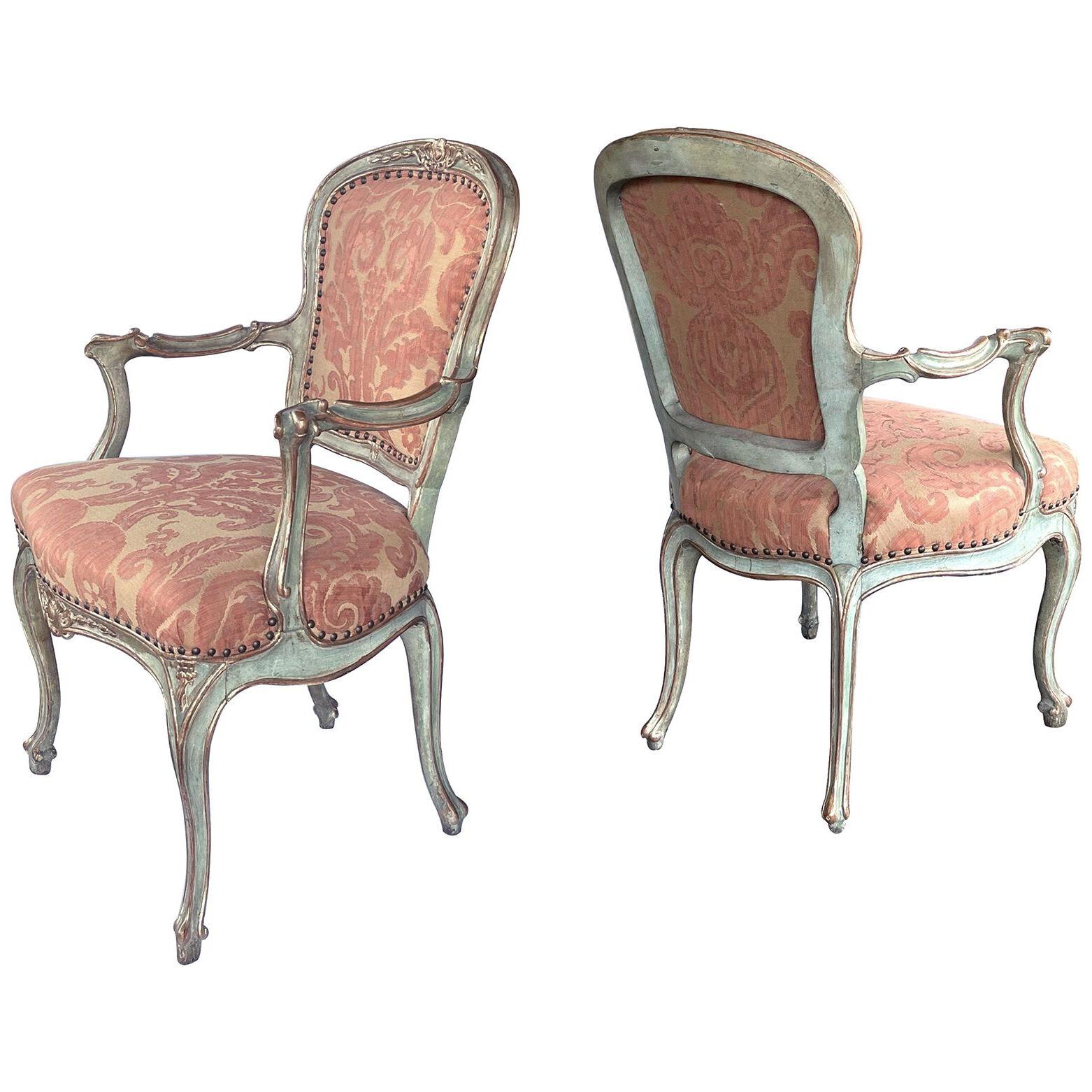 Shapely pair of Italian rococo style aqua painted and parcel-gilt armchairs